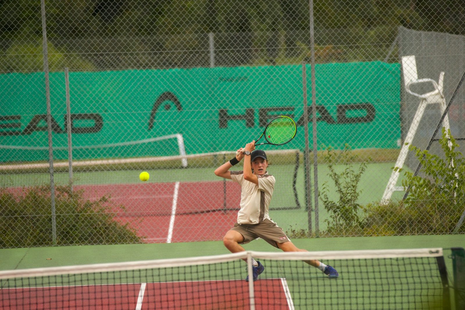 A man swinging a tennis racquet on court