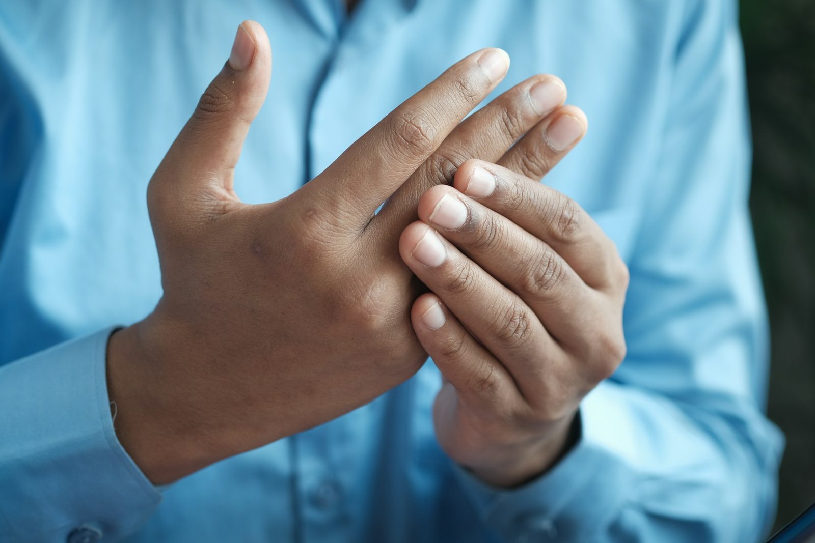 Person holding out their hand and wrist